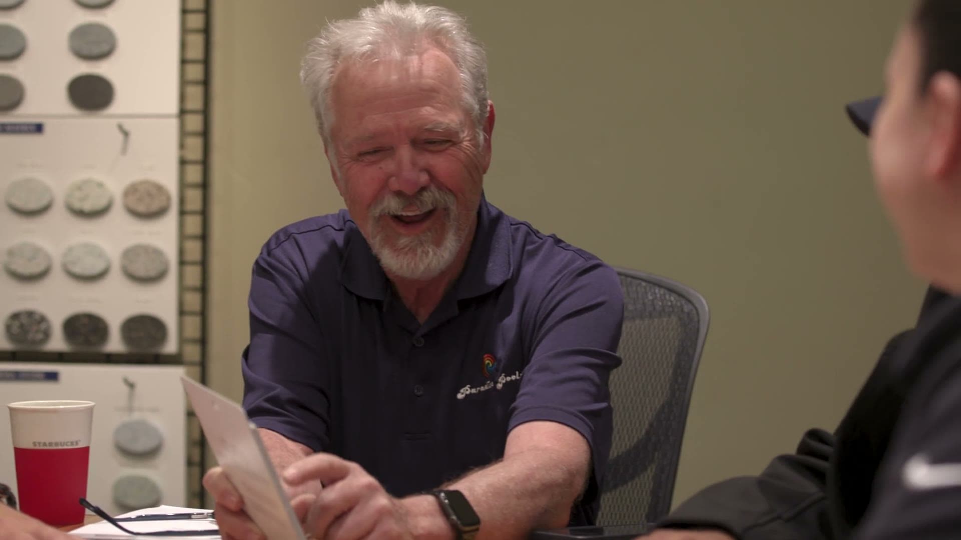 The owner of Paradise Pools sharing a laugh across the table